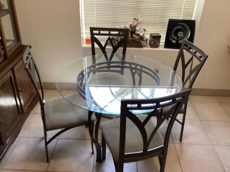 Round glass dining table with metal chairs