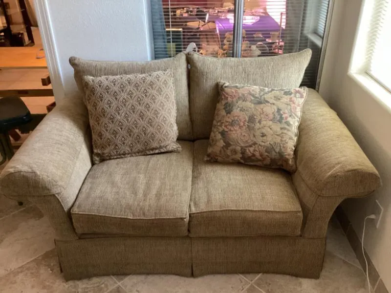 Beige loveseat with throw pillows