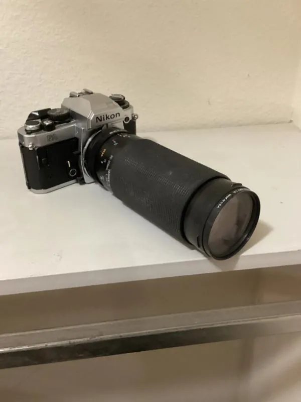 Film camera with a long zoom lens