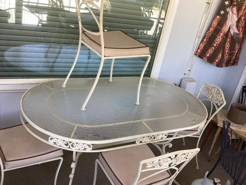 White wrought iron patio table and chairs