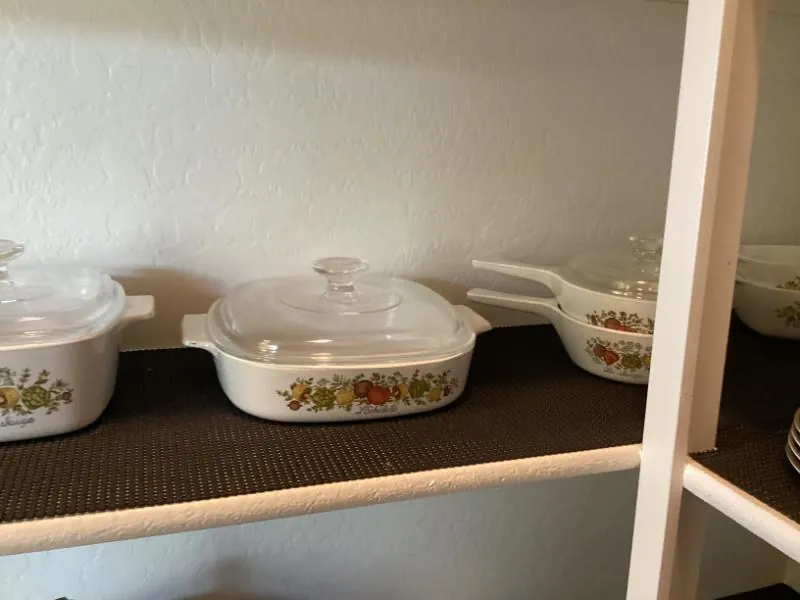 Shelf of Corning Ware casserole dishes