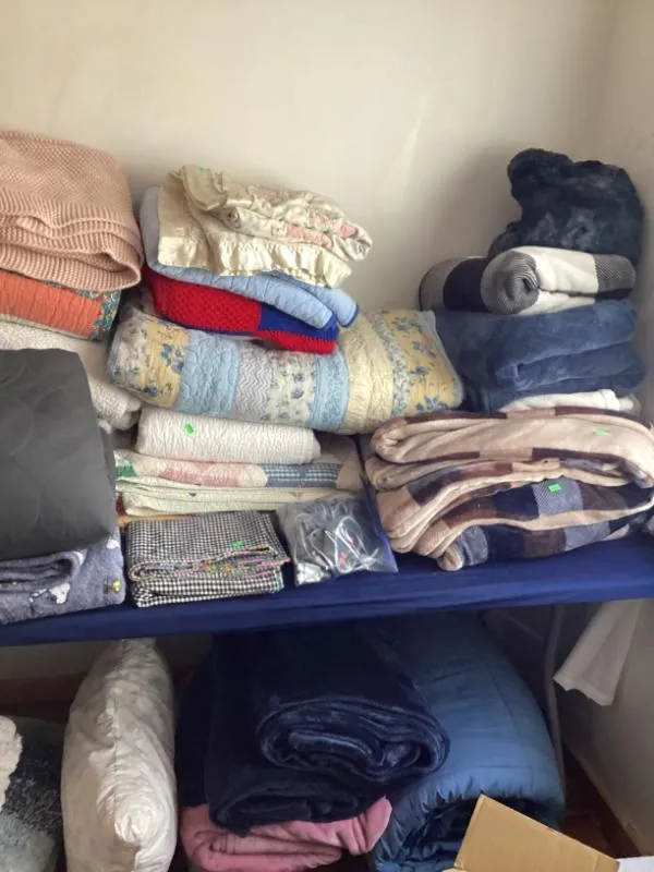 Table of folded clothing and blankets