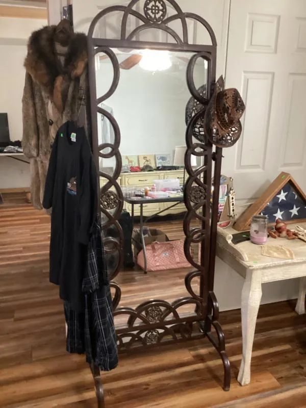 Ornate metal standing mirror