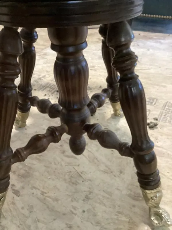Round stool with carved legs