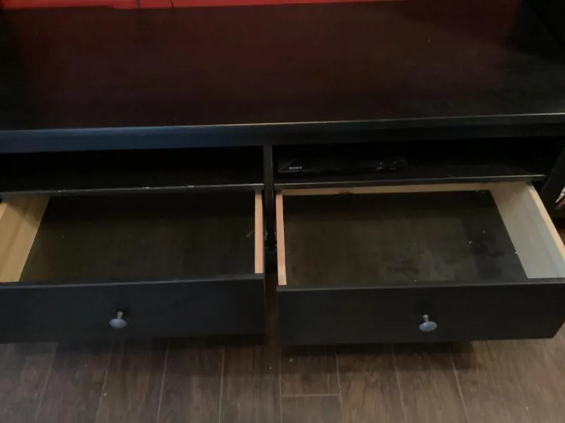 Black TV console with its drawers open
