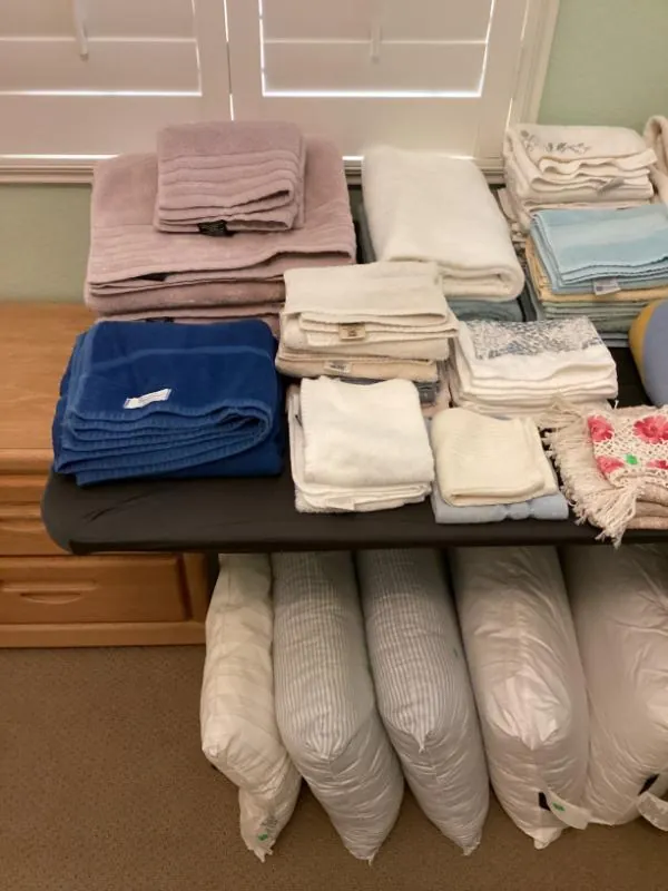 Table of folded linens, towels and pillows