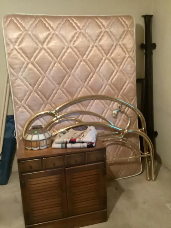 Brass bed frame with a mattress