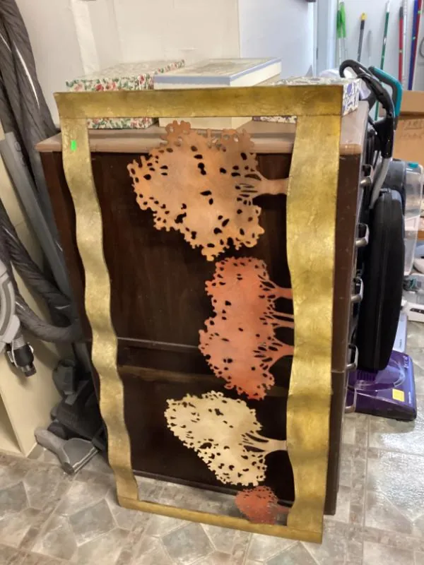 Metal leaf wall art in a gold frame