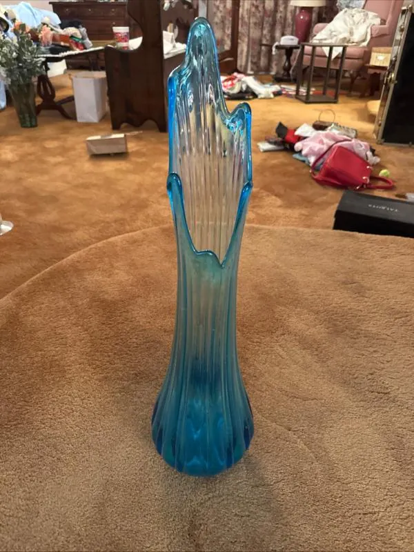 Tall blue glass vase with a fluted top