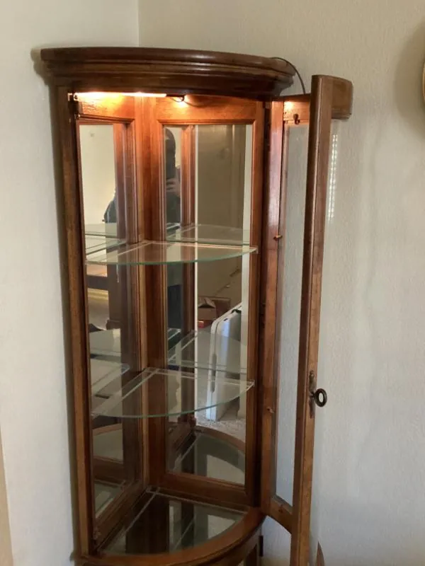 Lighted curved-glass curio cabinet