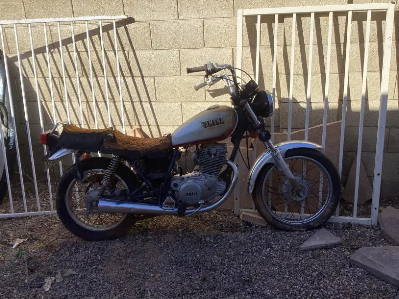 Motorcycle parked by a gate
