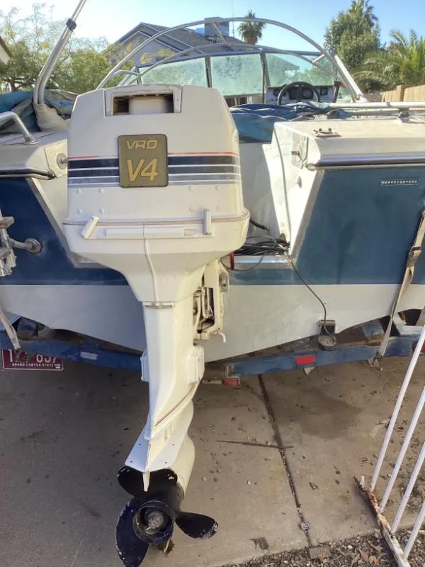 Boat with an outboard motor on a trailer