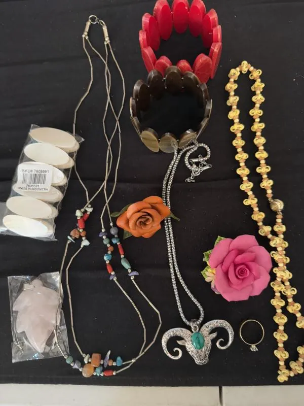 Colorful necklaces and jewelry laid out on a dark cloth
