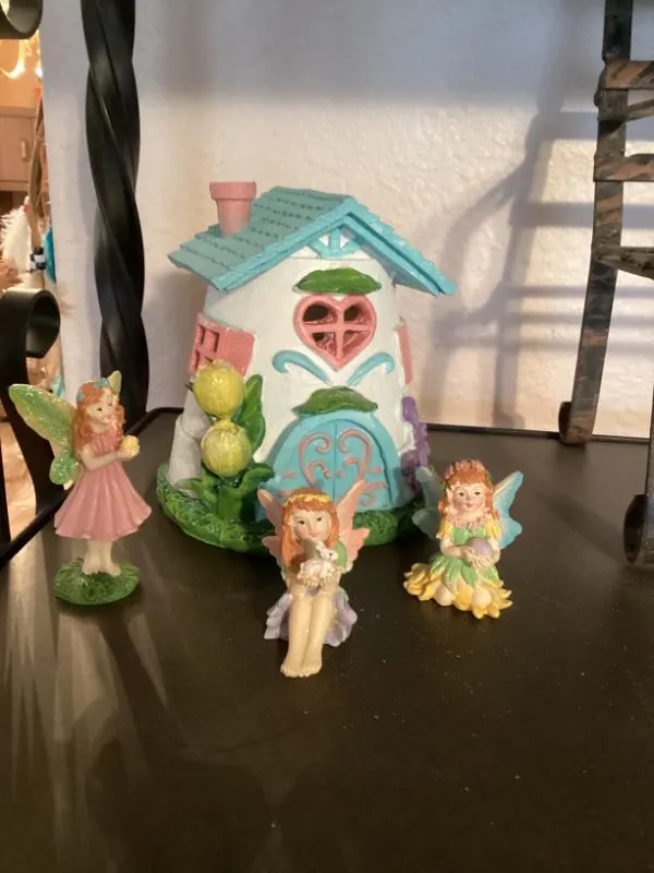 Fairy figurines and a small house-shaped decoration