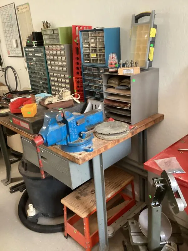 Workbench with a vise and parts drawers