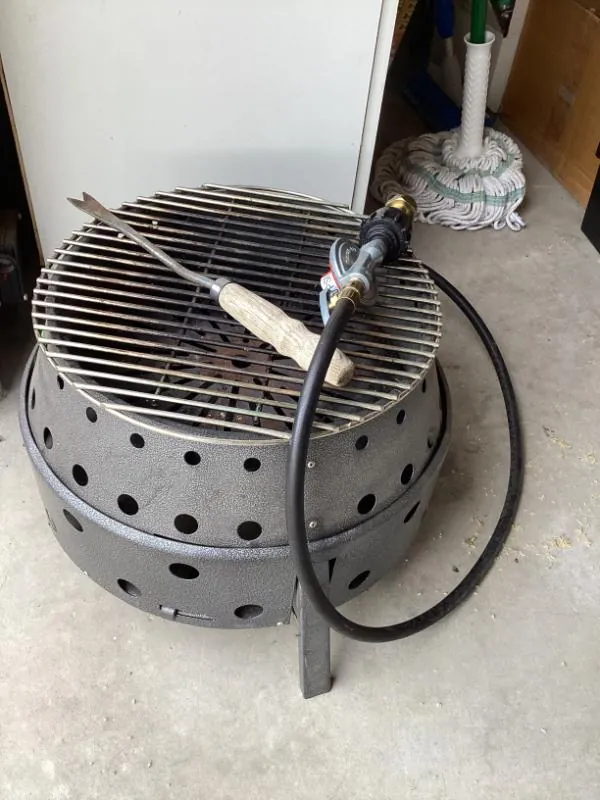 Round metal fire pit with a grill grate