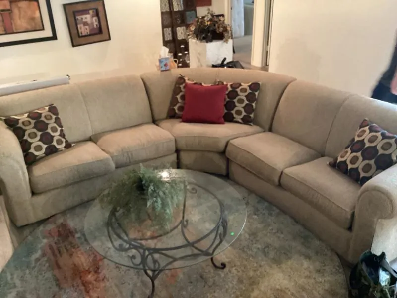 Beige sectional sofa around a glass coffee table