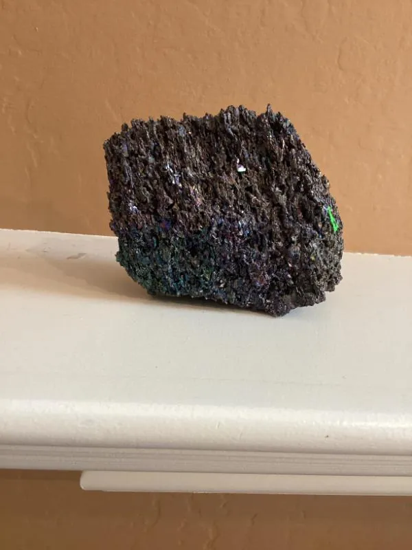 Dark sparkly mineral rock on a shelf