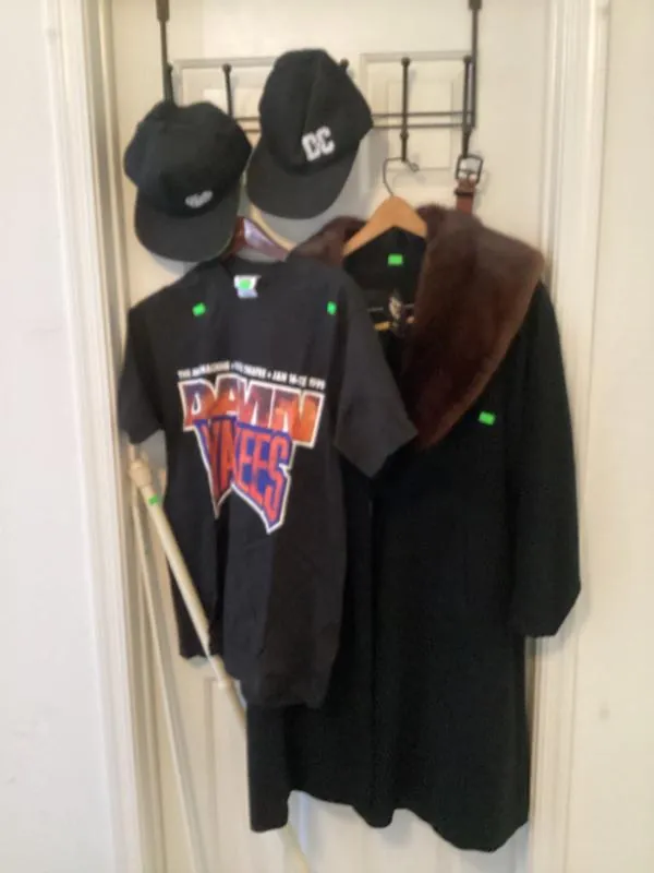 Black jackets and caps hanging on a door