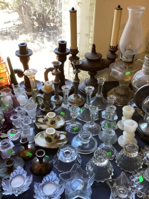 Table of glass oil lamps and candle holders