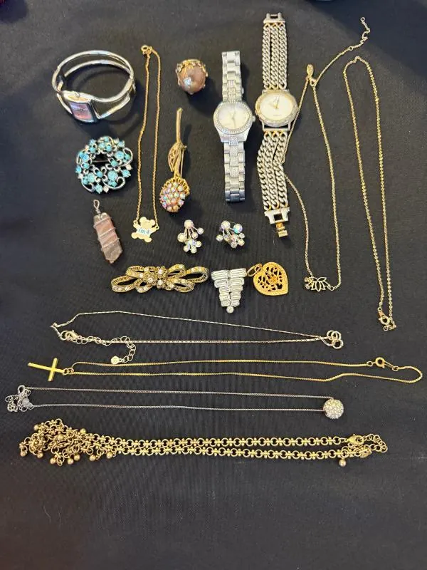 Watches, necklaces and jewelry laid out on a table