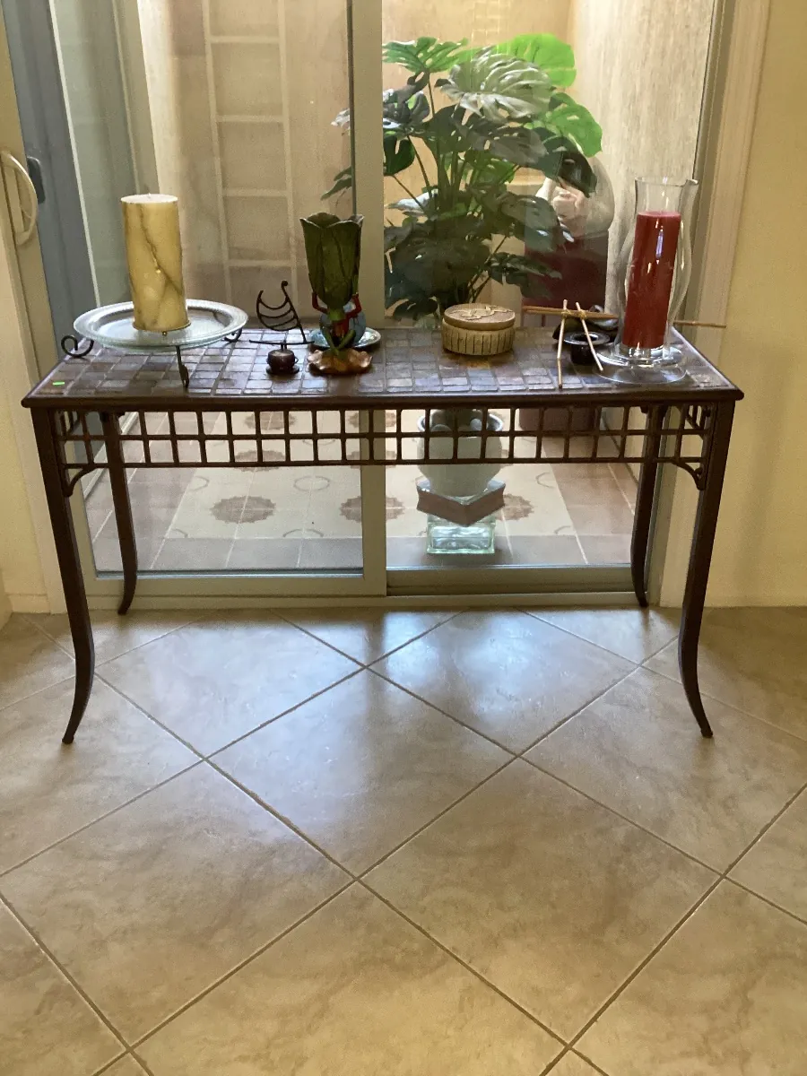 Entry table with a potted plant and decor