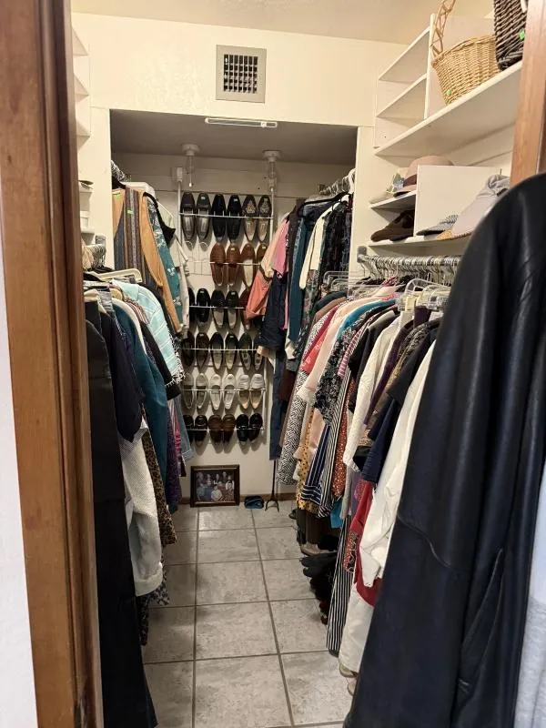 Walk-in closet full of clothing and shoes