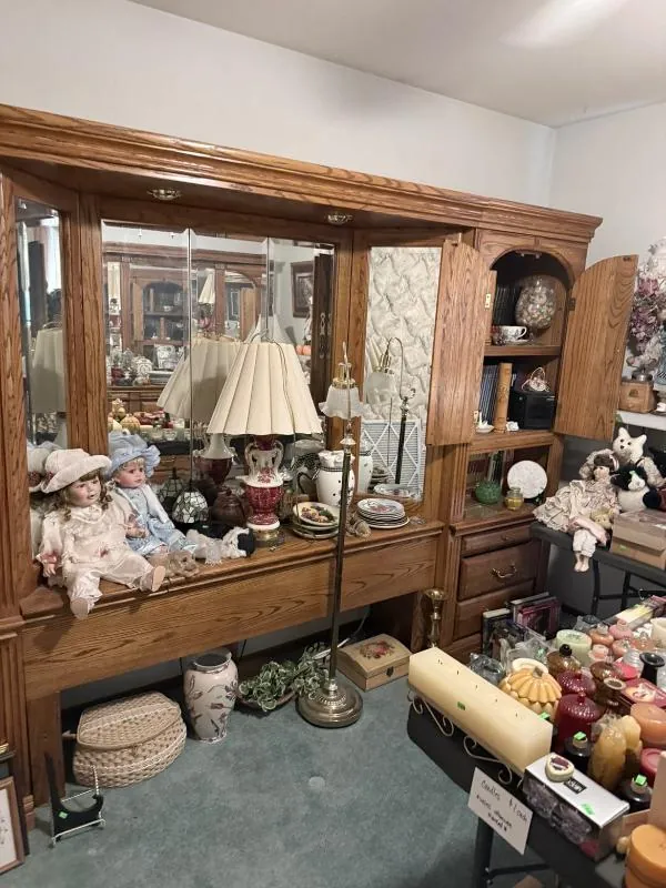 Dresser with a mirror, covered with dolls and decor