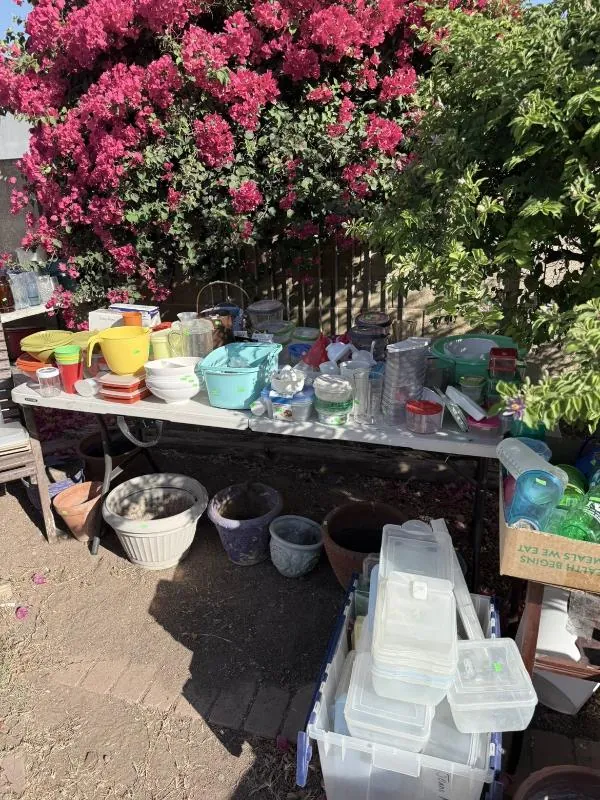 Outdoor table of colorful bowls and pottery