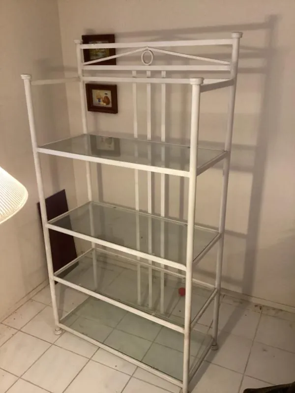 White metal shelf unit with glass shelves