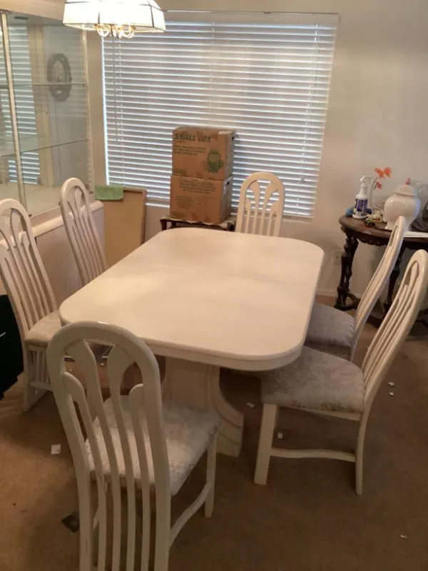 White dining table with four chairs