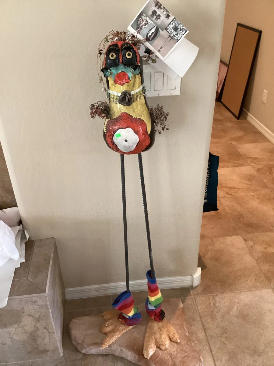 Colorful toucan sculpture on tall legs