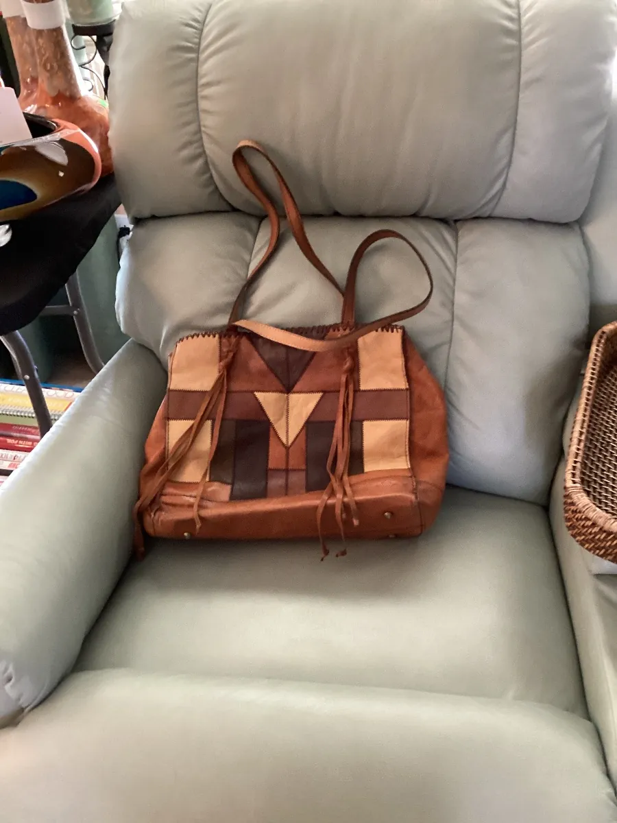 Brown patchwork handbag on a recliner