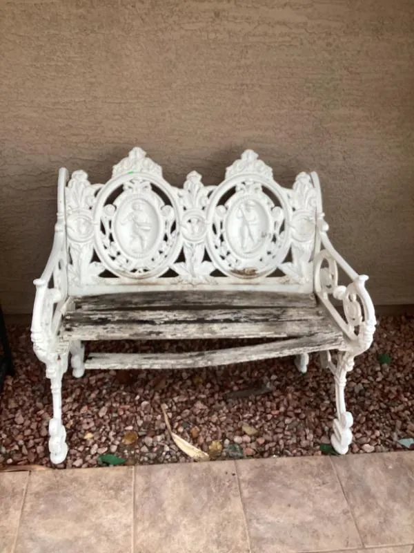 White ornate metal garden bench
