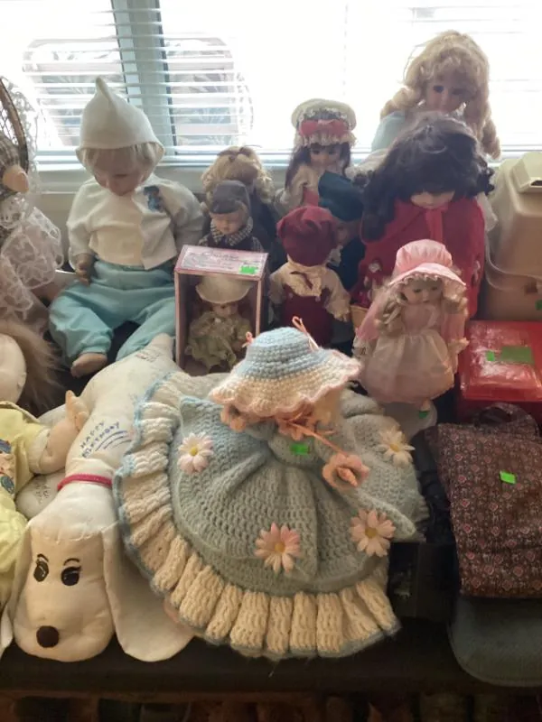 Collection of dolls on a bench