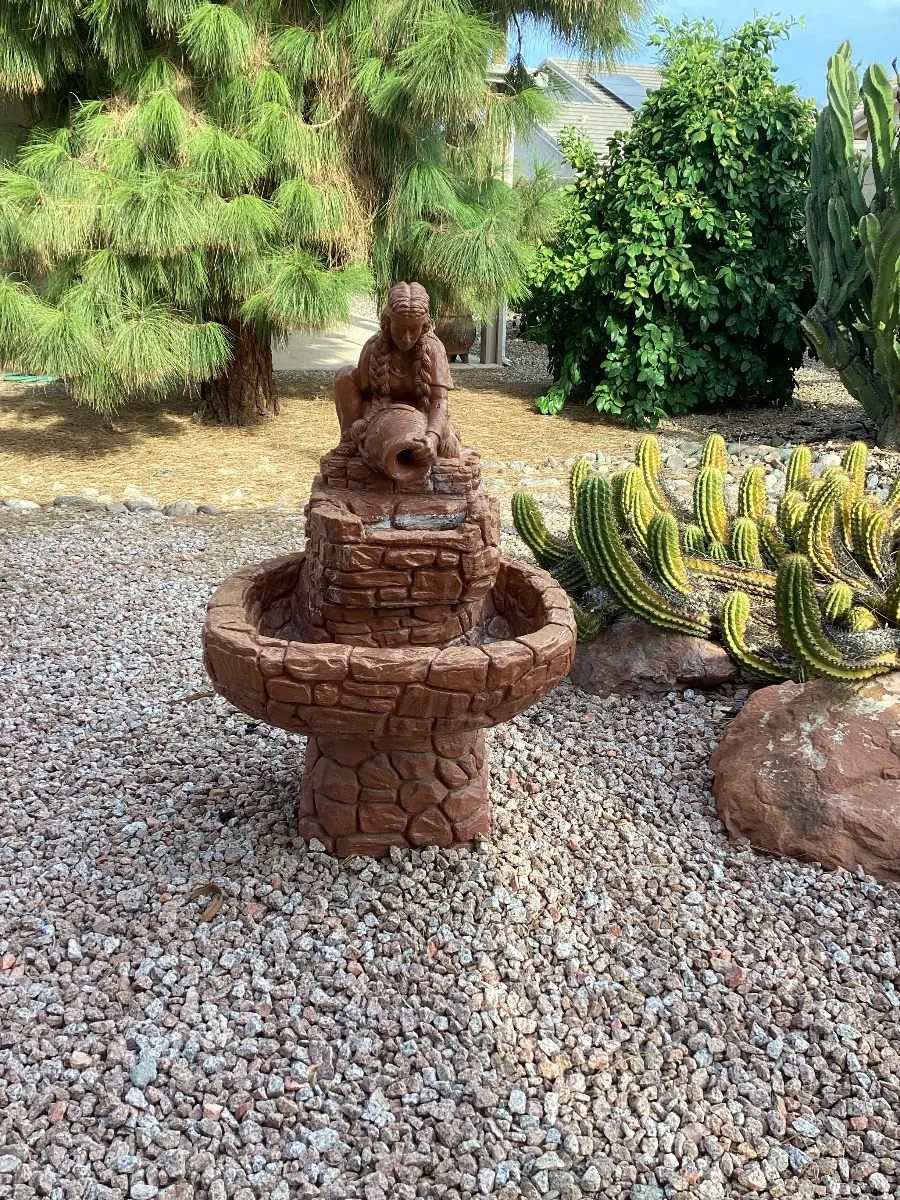 Tiered stone fountain in a desert yard