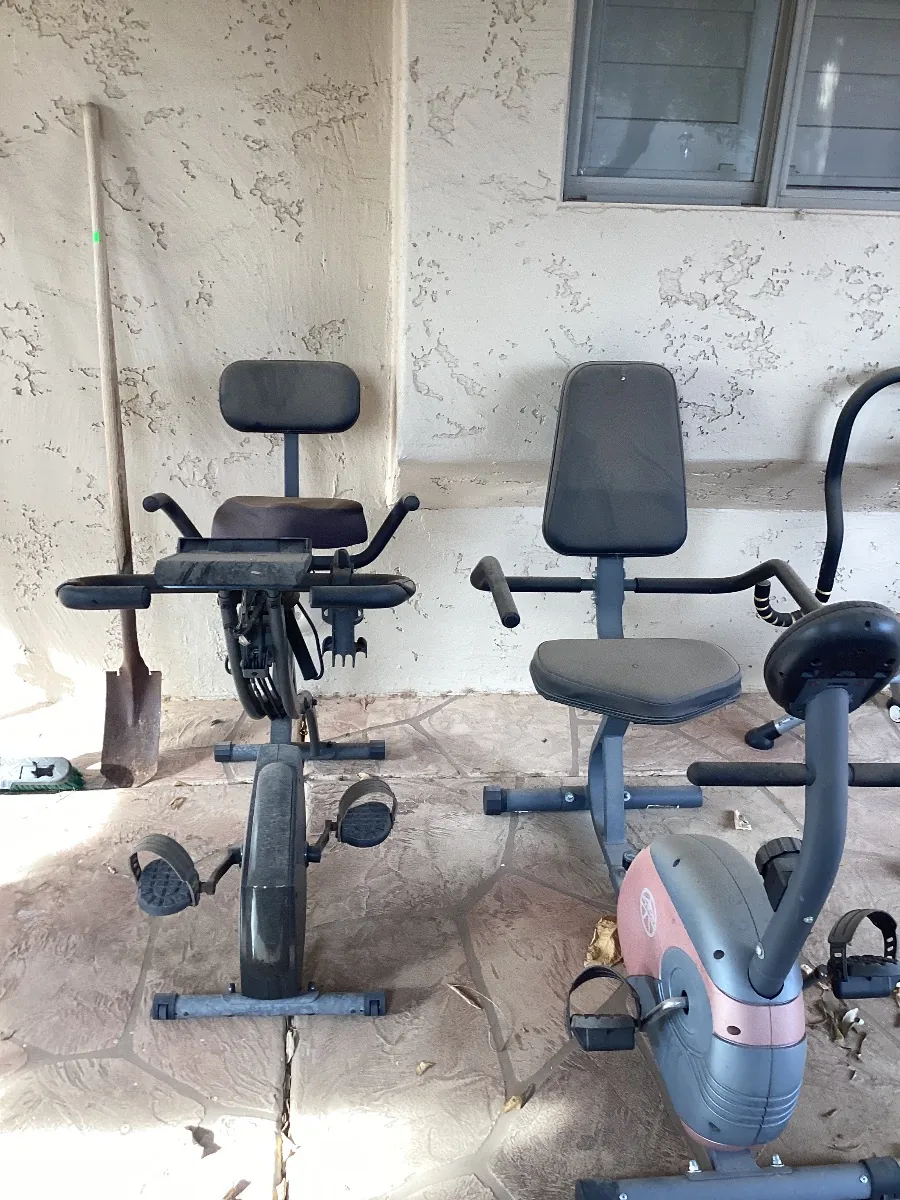 Two exercise bikes on a covered patio