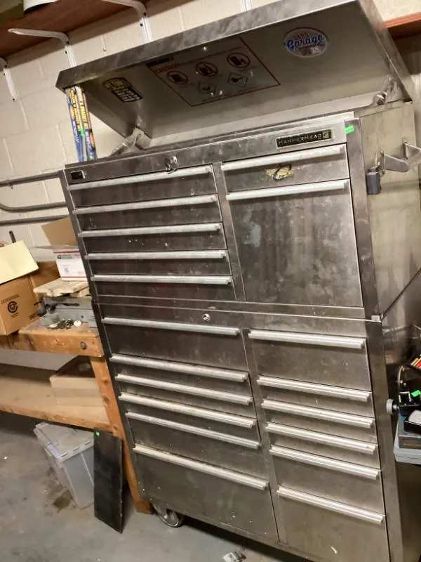 Stainless steel HammerHead rolling tool chest with its lid open in a garage