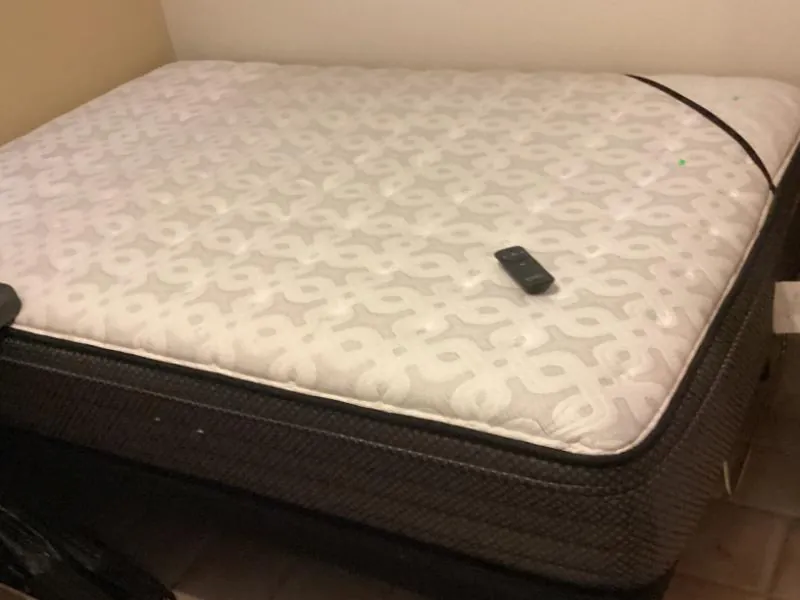 Mattress on an adjustable bed base, with its remote resting on top
