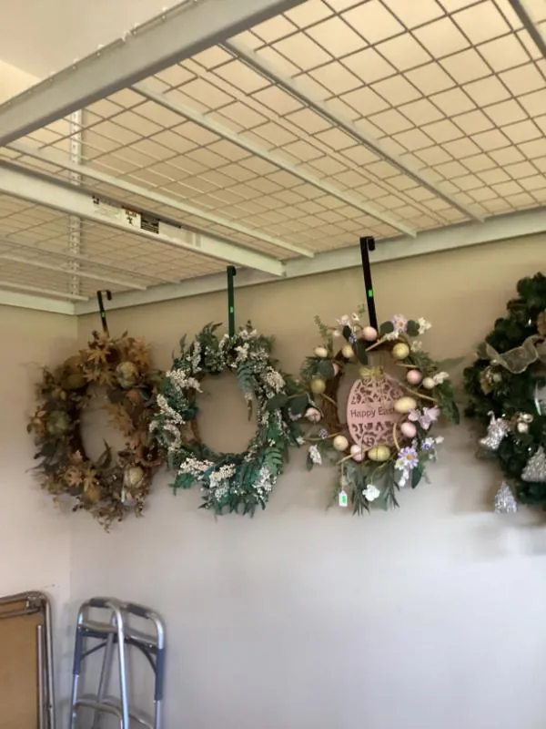Christmas wreaths hanging on a garage wall