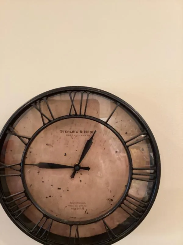 Large round wall clock with Roman numerals