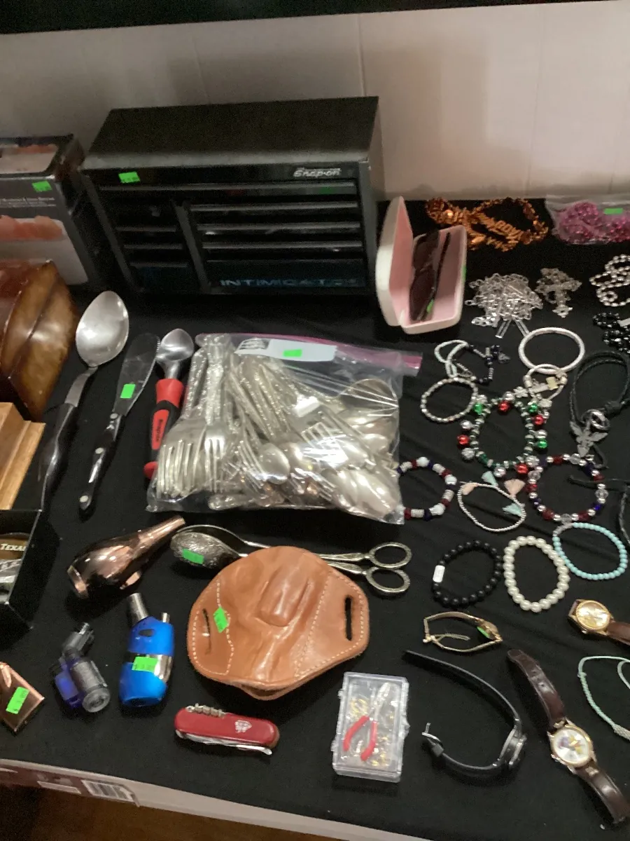 Table covered with bracelets, watches and jewelry