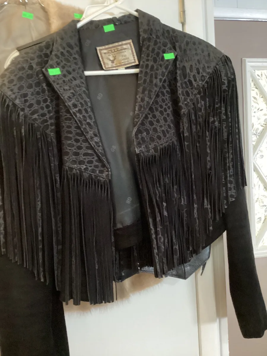 Black fringed jacket on a hanger
