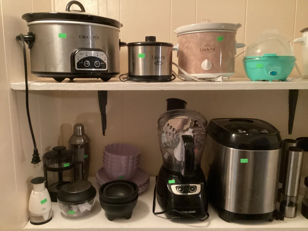 Shelf of slow cookers and small kitchen appliances