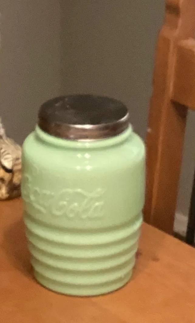 Green ribbed glass canister with a metal lid
