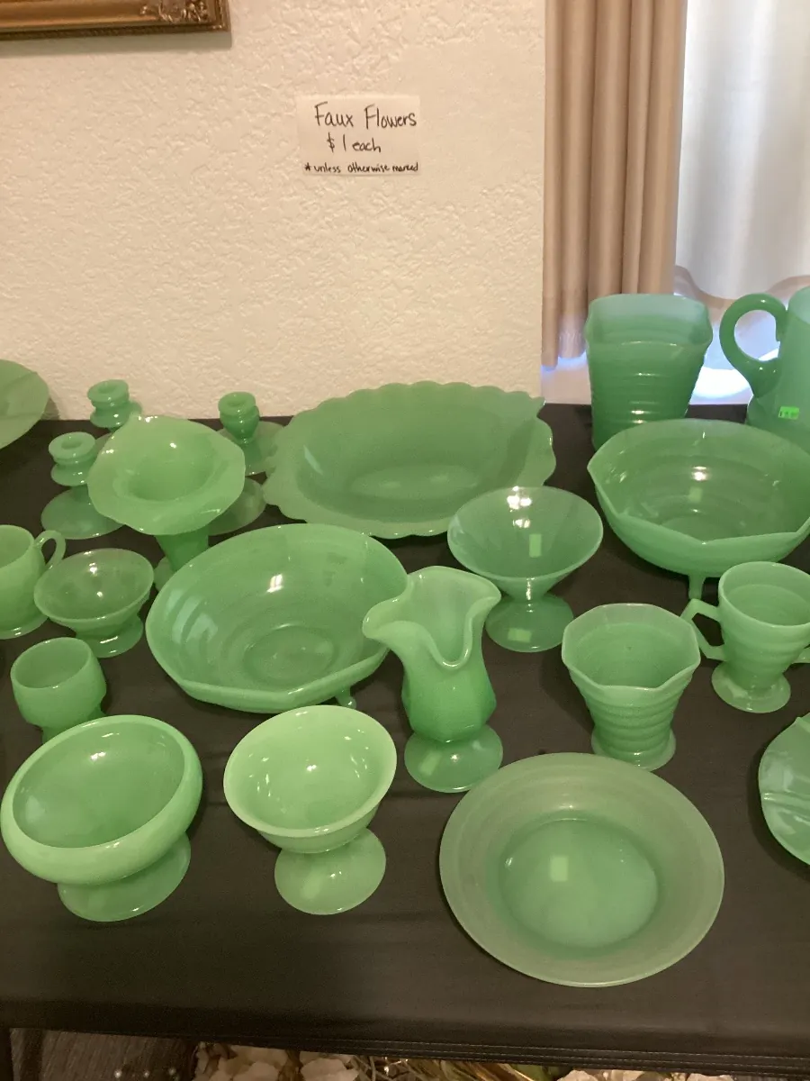 Table covered with green jadeite bowls, cups, pitchers and vases