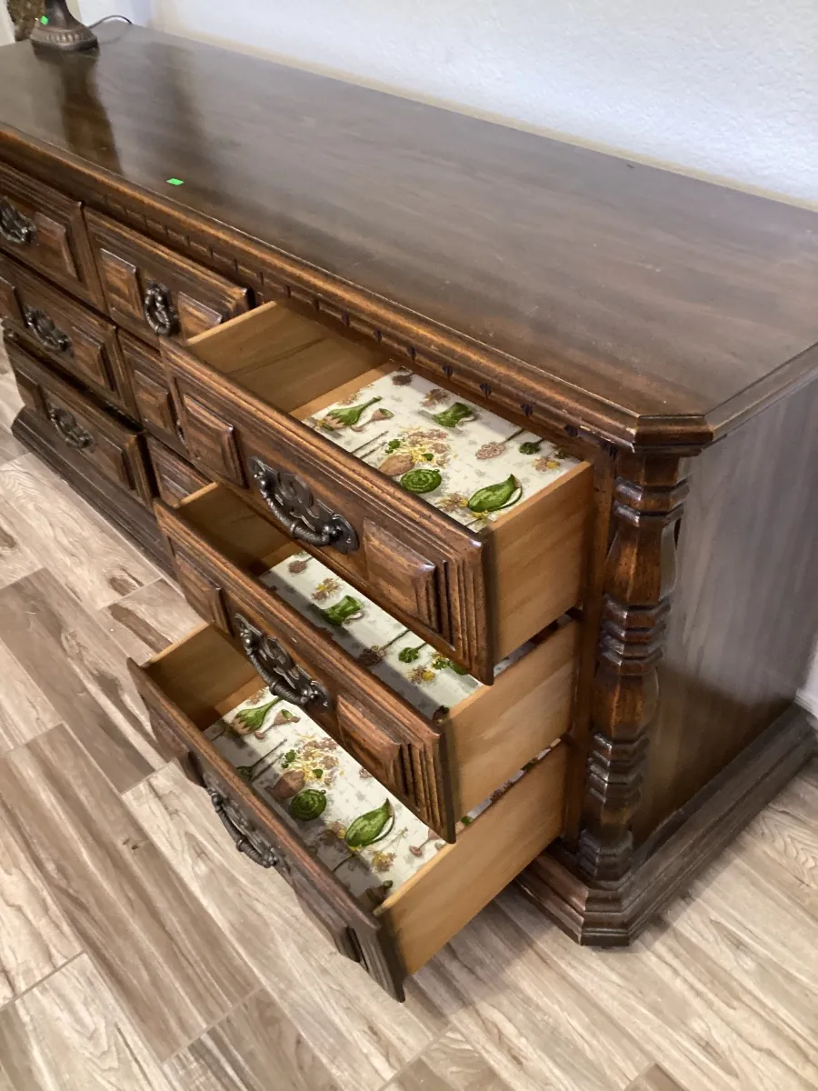 Long dark wood dresser with three drawers pulled open