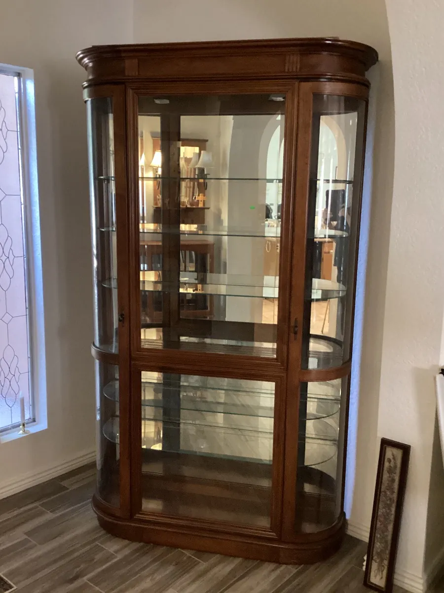 Lighted wood curio cabinet with curved glass sides